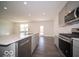 Well-lit kitchen features stainless steel appliances, gray cabinets, a white countertop, and a large island at 287 Lar Lan Dr, Danville, IN 46122