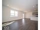 Spacious living room with hardwood floors, natural light, and an open layout leading to the kitchen area at 287 Lar Lan Dr, Danville, IN 46122