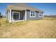 A view of the home's backyard with sliding glass doors and gray siding at 301 Lar Lan Dr, Danville, IN 46122