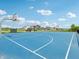 Bright blue community basketball court with hoops, benches, and court lines at 301 Lar Lan Dr, Danville, IN 46122