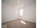 Bright bedroom featuring plush carpeting and a window offering a view of the outdoors at 301 Lar Lan Dr, Danville, IN 46122