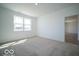 Bright bedroom featuring large window and neutral carpet at 301 Lar Lan Dr, Danville, IN 46122