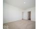 Neutral carpeted bedroom showcasing a view of the ensuite bathroom at 301 Lar Lan Dr, Danville, IN 46122