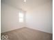 This bedroom features neutral carpet and a window to provide natural light at 301 Lar Lan Dr, Danville, IN 46122