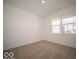 Cozy bedroom with neutral carpet, a large window, and ample natural light at 301 Lar Lan Dr, Danville, IN 46122