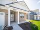 Inviting entryway with a covered porch and brick columns, leading to the front door at 301 Lar Lan Dr, Danville, IN 46122