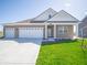 Charming single-story home with a three-car garage and a well-manicured lawn at 301 Lar Lan Dr, Danville, IN 46122