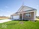 Well-maintained home featuring a brick exterior and a three-car garage at 301 Lar Lan Dr, Danville, IN 46122