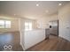 Open kitchen with stainless steel fridge, white cabinets, sink, and ample counter space at 301 Lar Lan Dr, Danville, IN 46122
