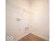 Bright laundry room with wooden floors and a wire rack for convenient storage at 301 Lar Lan Dr, Danville, IN 46122