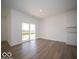 Open-concept living room featuring wood floors and access to outdoor patio at 301 Lar Lan Dr, Danville, IN 46122