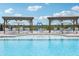 Community pool with lounge chairs and umbrellas for relaxing by the water on a sunny day at 301 Lar Lan Dr, Danville, IN 46122