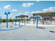Community splash pad with tables and chairs offering shade for to enjoy during the summer at 301 Lar Lan Dr, Danville, IN 46122