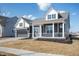 Charming two-story home with a covered front porch, gray siding, stone accents, and an attached two-car garage at 798 Leila Mae Ln, Westfield, IN 46074