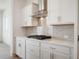Modern kitchen details featuring a gas cooktop, stylish backsplash, quartz countertops, and stainless steel hood at 798 Leila Mae Ln, Westfield, IN 46074