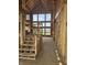 The home's entryway features a staircase with unfinished wood and large windows for natural light, exposed framing at 8030 Totton Ct, Zionsville, IN 46077