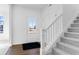 Bright entryway features wood floors, a staircase with carpet, and a front door with glass panels at 9344 Anthem Ave, Plainfield, IN 46168