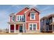 Charming two-story home showcasing red siding, white trim, and covered porch enhancing curb appeal at 9344 Anthem Ave, Plainfield, IN 46168