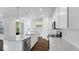 Open kitchen featuring white cabinets, granite counters, and an island with a sink and dishwasher at 9344 Anthem Ave, Plainfield, IN 46168