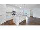 Bright kitchen featuring white cabinets, granite countertops, stainless steel appliances, and wood flooring at 9344 Anthem Ave, Plainfield, IN 46168
