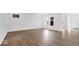 Spacious living room featuring wood floors, white walls, and ample natural light from the large windows at 9344 Anthem Ave, Plainfield, IN 46168
