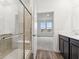 Elegant bathroom featuring a glass-enclosed shower, modern vanity, and access to a bedroom at 235 Hunters Ridge Dr, Danville, IN 46122