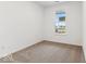 Bright bedroom with a large window, neutral carpeting and white walls at 235 Hunters Ridge Dr, Danville, IN 46122