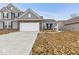 Charming two-story home with gray siding, brick accents, and an attached two-car garage at 235 Hunters Ridge Dr, Danville, IN 46122