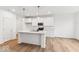 Bright kitchen with a center island, white cabinets, and stainless steel appliances at 235 Hunters Ridge Dr, Danville, IN 46122