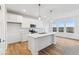 Well-lit kitchen featuring a center island, stainless steel appliances, and hardwood floors at 235 Hunters Ridge Dr, Danville, IN 46122