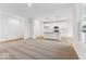 Open-concept living space with carpet and wood flooring, seamlessly connecting to the kitchen area at 235 Hunters Ridge Dr, Danville, IN 46122