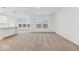 Bright and airy living room featuring neutral carpet and large windows offering backyard views at 235 Hunters Ridge Dr, Danville, IN 46122