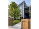 Modern, blue two-story townhome with a well-manicured front yard and a charming wood fence at 1213 Cottage Ave, Indianapolis, IN 46203