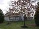 Home's backyard featuring a well-maintained lawn, black chain link fence and mature trees for privacy and beauty at 744 Helm Dr, Avon, IN 46123