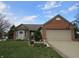 Charming single-story home with a well-maintained lawn and a two-car garage showcasing curb appeal at 744 Helm Dr, Avon, IN 46123