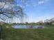 Picturesque pond with a walking path and bench seating, creating a tranquil community space for residents to enjoy at 744 Helm Dr, Avon, IN 46123