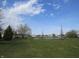 Scenic community pond surrounded by lush green space and walking paths offers a serene and picturesque setting at 744 Helm Dr, Avon, IN 46123