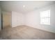 Bedroom featuring neutral carpet and a window at 7904 Magnolia St, New Palestine, IN 46163
