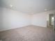 Spacious bedroom featuring neutral carpet and a view of the ensuite bathroom at 7904 Magnolia St, New Palestine, IN 46163