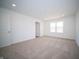 Bedroom with a large window, neutral walls, recessed lighting, and tan carpeting at 7904 Magnolia St, New Palestine, IN 46163