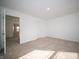 Bedroom with neutral carpet and a doorway to another room at 7904 Magnolia St, New Palestine, IN 46163