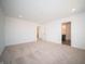 Bright bedroom with neutral carpet, recessed lighting, and a doorway to another room at 7904 Magnolia St, New Palestine, IN 46163