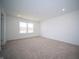 Bedroom with a large window, neutral walls, recessed lighting, and tan carpeting at 7904 Magnolia St, New Palestine, IN 46163