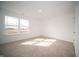 Bright bedroom featuring a large window and neutral carpet, offering a serene and comfortable space at 7904 Magnolia St, New Palestine, IN 46163