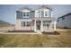Charming two-story home with brick and siding facade, covered front porch, and well-maintained lawn at 7904 Magnolia St, New Palestine, IN 46163