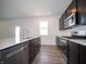 Modern kitchen with stainless steel appliances and an island sink with views to the yard at 7904 Magnolia St, New Palestine, IN 46163
