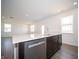 Kitchen island with a stainless steel dishwasher and dark cabinetry at 7904 Magnolia St, New Palestine, IN 46163