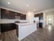 Modern kitchen with an island, stainless steel appliances, and open layout at 7904 Magnolia St, New Palestine, IN 46163