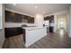 Stylish kitchen with a large island, stainless appliances, and dark cabinetry at 7904 Magnolia St, New Palestine, IN 46163