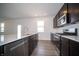 Modern kitchen featuring a stainless steel gas range and dark cabinetry at 7904 Magnolia St, New Palestine, IN 46163